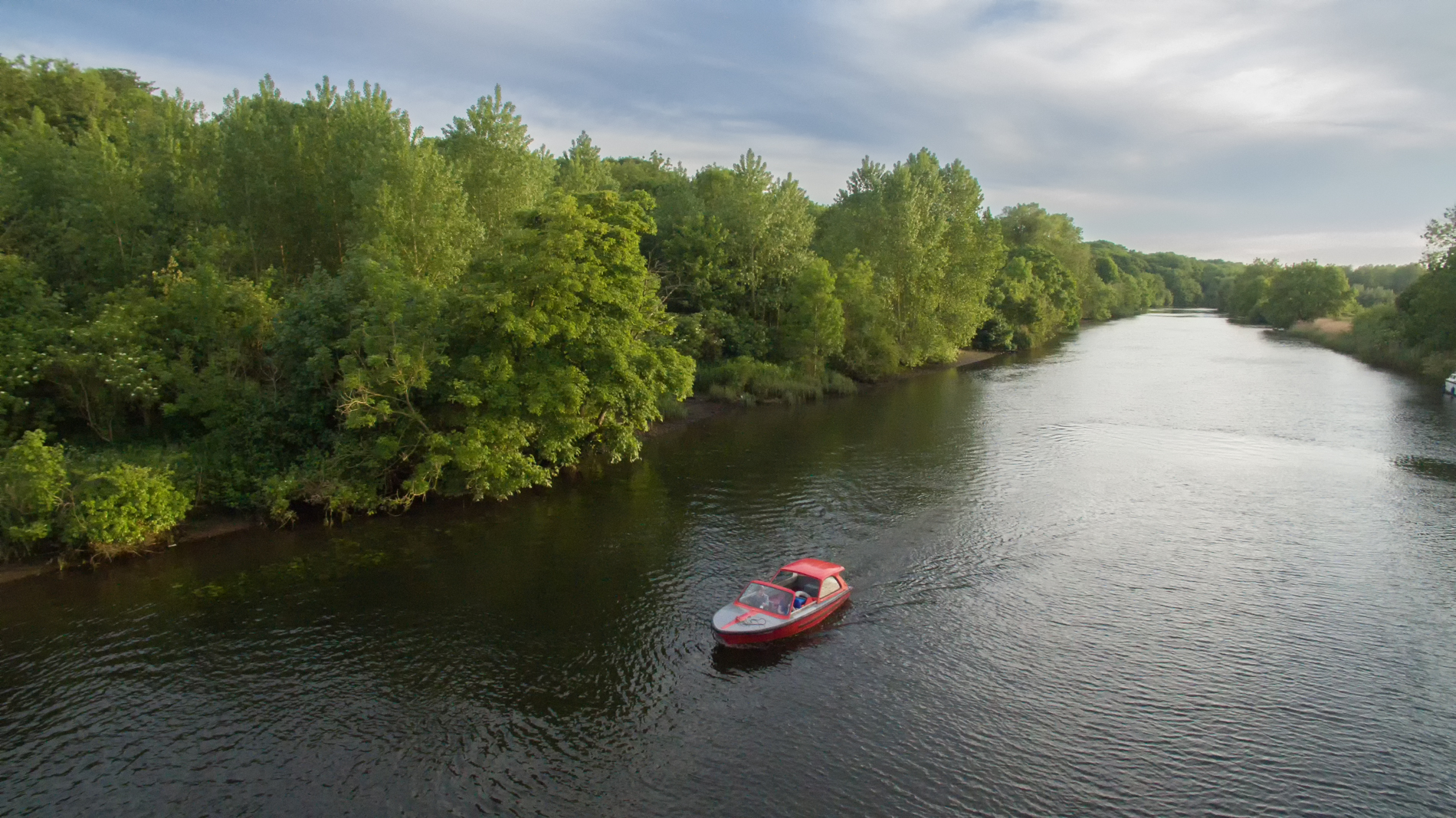 Aerial view of river with Bishy Day Boat